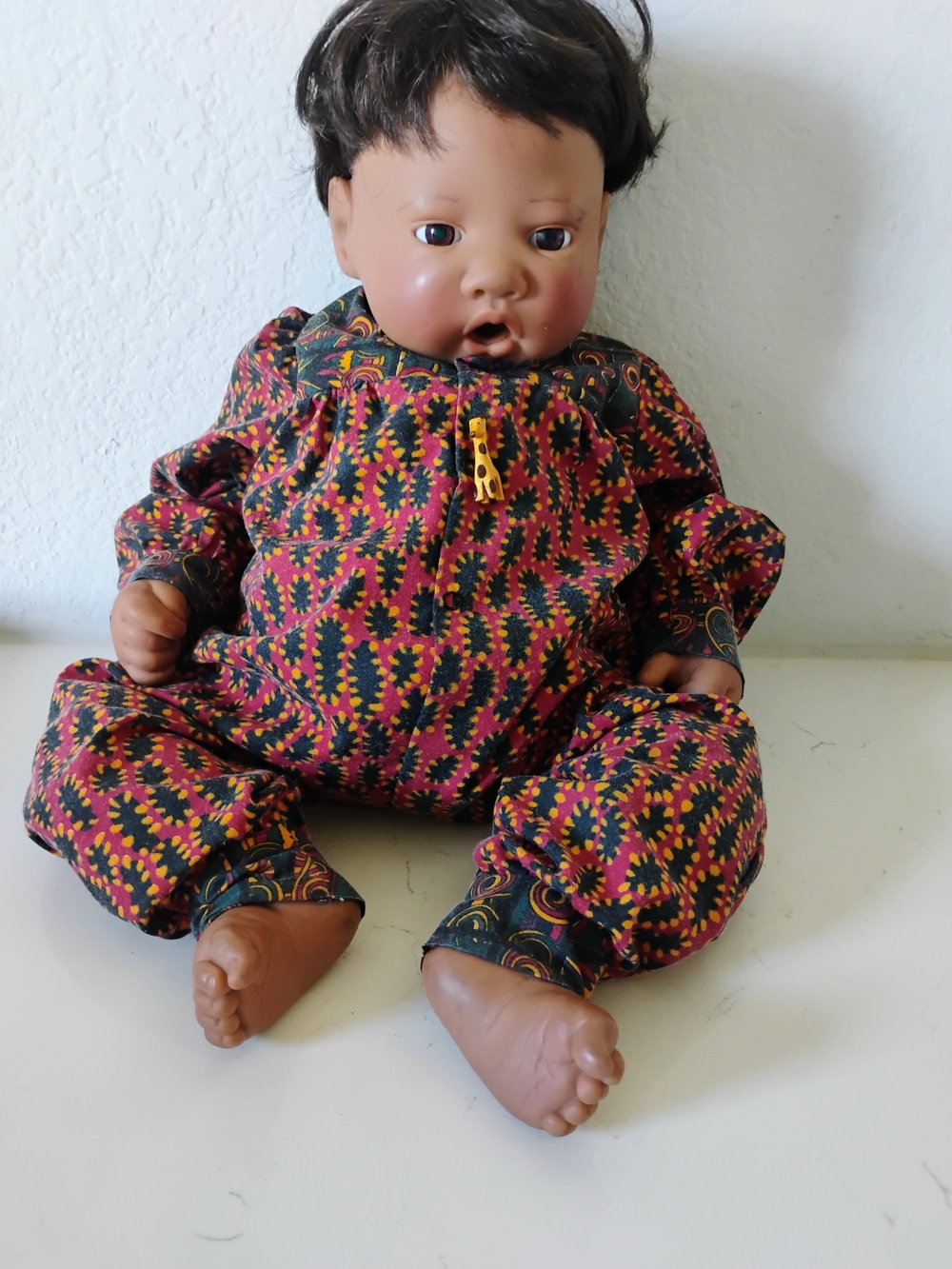 Plush Baby Doll in Multicolor Patterned Outfit - Pink & Black